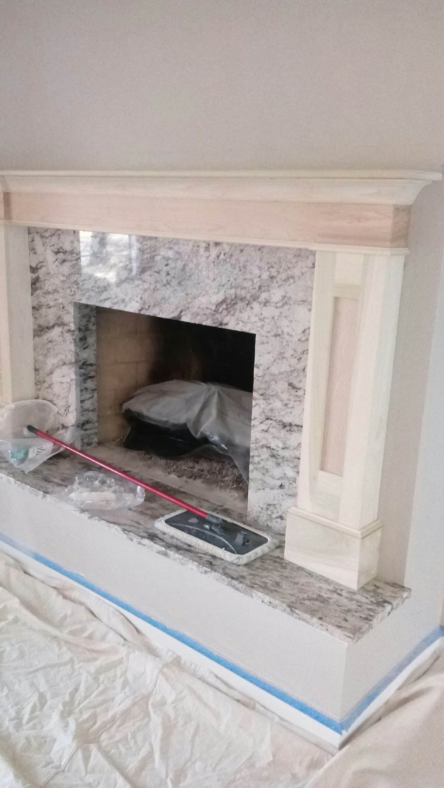 Marble fireplace with a mop on it