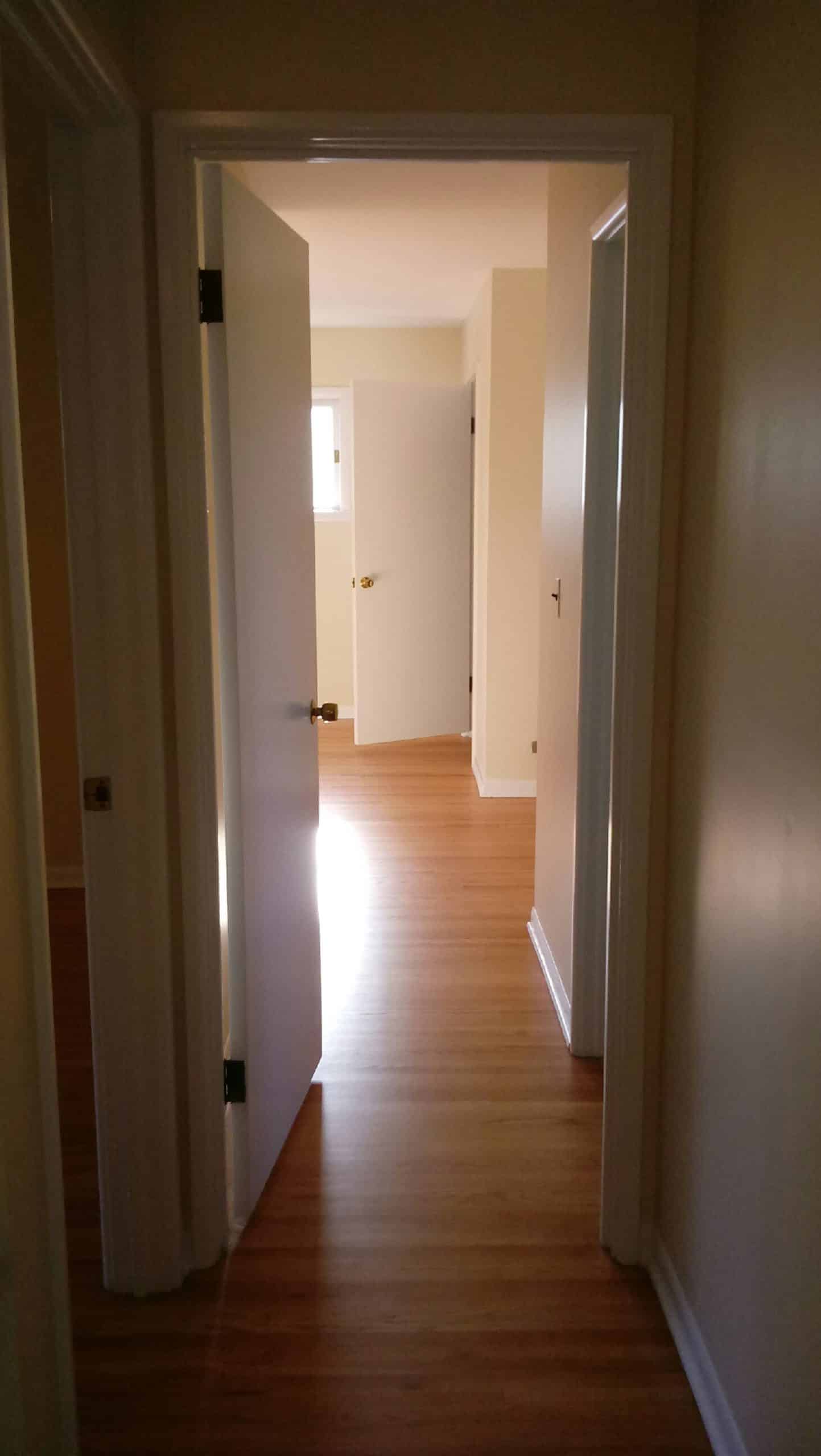 Narrow hallway leading into a room